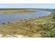 Wide aerial view of multiple docks extending into the water surrounded by marshland at 2649 Starfish Dr, Johns Island, SC 29455