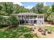 Spacious backyard featuring a deck, a fire pit area with seating, and lush green lawn at 2649 Starfish Dr, Johns Island, SC 29455