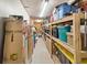 Long storage room with shelves filled with organized plastic containers and cardboard boxes at 2649 Starfish Dr, Johns Island, SC 29455