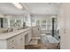 Luxurious bathroom featuring double vanity sinks, a glass-enclosed shower, and natural light at 2649 Starfish Dr, Johns Island, SC 29455