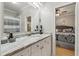 Bright bathroom featuring a white marble countertop vanity and view into the connected bedroom at 2649 Starfish Dr, Johns Island, SC 29455