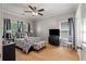 Well-lit bedroom featuring hardwood floors, a ceiling fan, and two windows providing plenty of natural light at 2649 Starfish Dr, Johns Island, SC 29455