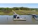 Aerial view of a private dock on the water with boat, gazebo, and long wooden walkways to the mainland at 2649 Starfish Dr, Johns Island, SC 29455
