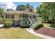 Charming home featuring a screened front porch with white railings, a gray foundation, and mature landscaping at 2649 Starfish Dr, Johns Island, SC 29455