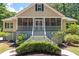 Inviting facade showcasing an expansive screened front porch and well-manicured landscaping at 2649 Starfish Dr, Johns Island, SC 29455