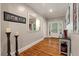 Inviting foyer with hardwood flooring, stylish decor, and a clear view of the front entrance with glass sidelights at 2649 Starfish Dr, Johns Island, SC 29455