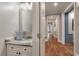 Hallway featuring a bathroom with a granite vanity, and hardwood floors leading to other rooms at 2649 Starfish Dr, Johns Island, SC 29455