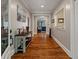 Entry hallway featuring hardwood floors, neutral paint, decorative furniture, and an open view into living area at 2649 Starfish Dr, Johns Island, SC 29455