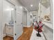 Bright hallway featuring hardwood floors and access to a well-lit bathroom with granite vanity at 2649 Starfish Dr, Johns Island, SC 29455