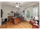 Stylish office featuring a large desk, hardwood floors, a ceiling fan and natural light at 2649 Starfish Dr, Johns Island, SC 29455