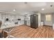 Well-lit kitchen area featuring white cabinets, modern appliances, and wood-look flooring at 2649 Starfish Dr, Johns Island, SC 29455