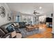 Bright living room featuring a leather sectional sofa, wooden coffee table, and hardwood floors at 2649 Starfish Dr, Johns Island, SC 29455