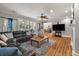 Spacious living room with hardwood floors, ample seating, and a view into the dining area at 2649 Starfish Dr, Johns Island, SC 29455