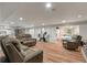 Spacious living room with wood-look flooring, comfortable seating, and ample natural light at 2649 Starfish Dr, Johns Island, SC 29455