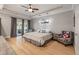 Serene main bedroom with tray ceilings, hardwood floors, and a sitting area with backyard views at 2649 Starfish Dr, Johns Island, SC 29455