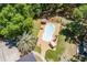 Aerial view of a kidney-shaped pool with surrounding patio, lounge chairs, and lush landscaping at 2649 Starfish Dr, Johns Island, SC 29455