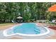 In-ground pool featuring steps, a surrounding patio with lounge chairs, and mature trees at 2649 Starfish Dr, Johns Island, SC 29455