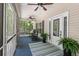 Inviting screened porch with rocking chairs, potted plants, an outdoor rug, and ceiling fans for comfort at 2649 Starfish Dr, Johns Island, SC 29455