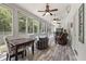 Bright sunroom with lots of windows, ceiling fans, stylish furniture, and views of the surrounding woods at 2649 Starfish Dr, Johns Island, SC 29455