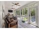 Bright sunroom with ample windows offering relaxing views and hardwood flooring at 2649 Starfish Dr, Johns Island, SC 29455