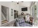 Bright sunroom featuring wood-paneled walls, a small kitchenette, and access to a staircase at 2649 Starfish Dr, Johns Island, SC 29455