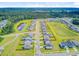 Aerial view of a residential community with pond and a field at 266 Torslanda Ln, Summerville, SC 29486