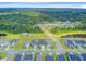 Aerial view of a residential community with tree-lined streets, ponds, and lush green surroundings at 266 Torslanda Ln, Summerville, SC 29486