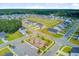 Community aerial showing homes surrounding the playground with a green common area and nearby soccer field at 266 Torslanda Ln, Summerville, SC 29486
