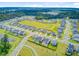 Aerial view of a residential community with pond and a field at 266 Torslanda Ln, Summerville, SC 29486