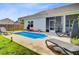 Backyard pool with lounge chairs and screened porch at 266 Torslanda Ln, Summerville, SC 29486