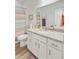 Bathroom features toilet, vanity with countertop and colorful striped shower curtain at 266 Torslanda Ln, Summerville, SC 29486