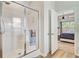 Bathroom features glass enclosed shower with tile surround next to bedroom doorway at 266 Torslanda Ln, Summerville, SC 29486