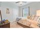 Cozy bedroom with neutral tones, a ceiling fan, and natural light from the window at 266 Torslanda Ln, Summerville, SC 29486