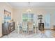 Bright dining room features a wooden table, chandelier and wine cooler at 266 Torslanda Ln, Summerville, SC 29486