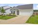 Well-maintained one-story home with a two car garage and a green lawn at 266 Torslanda Ln, Summerville, SC 29486