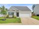 Charming single-story home with a well-manicured lawn and a two car garage at 266 Torslanda Ln, Summerville, SC 29486