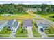 A street view of three modern homes with well-manicured lawns, landscaping, and paved driveways at 266 Torslanda Ln, Summerville, SC 29486