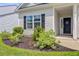 Charming front entrance with a decorative wreath and lush landscaping at 266 Torslanda Ln, Summerville, SC 29486