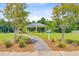 A lovely view of the community gazebo with manicured landscaping, shrubbery, and beautiful trees at 266 Torslanda Ln, Summerville, SC 29486