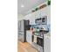 Kitchen features stainless steel appliances, white cabinets and tiled backsplash at 266 Torslanda Ln, Summerville, SC 29486
