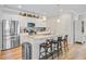 Open kitchen features granite countertops, stainless steel appliances, and breakfast bar seating at 266 Torslanda Ln, Summerville, SC 29486