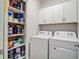 Laundry room features a side-by-side washer and dryer and extra storage shelving at 266 Torslanda Ln, Summerville, SC 29486