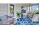 Inviting covered patio with stylish furniture, a mosaic table, and a ceiling fan at 266 Torslanda Ln, Summerville, SC 29486