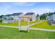 View of a wooden swing set in the community play area with a sidewalk at 266 Torslanda Ln, Summerville, SC 29486