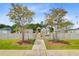 Neighborhood playground surrounded by a white picket fence featuring climbing and swinging fun at 266 Torslanda Ln, Summerville, SC 29486