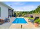 Inviting backyard pool area with lounge chairs, privacy fence, and landscaping at 266 Torslanda Ln, Summerville, SC 29486