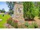 Community entrance sign made of stone with 'PM' lettering, surrounded by flowers and greenery at 266 Torslanda Ln, Summerville, SC 29486