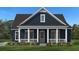 A charming home with a deep navy blue exterior and classic white trim and porch at 2872 Edenborough Rd, Johns Island, SC 29455