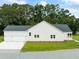 Exterior view of a house showcasing a two-car garage, and spacious lawn and driveway at 2872 Edenborough Rd, Johns Island, SC 29455