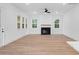 Bright living room with a modern fireplace, light wood floors, and multiple windows at 2872 Edenborough Rd, Johns Island, SC 29455